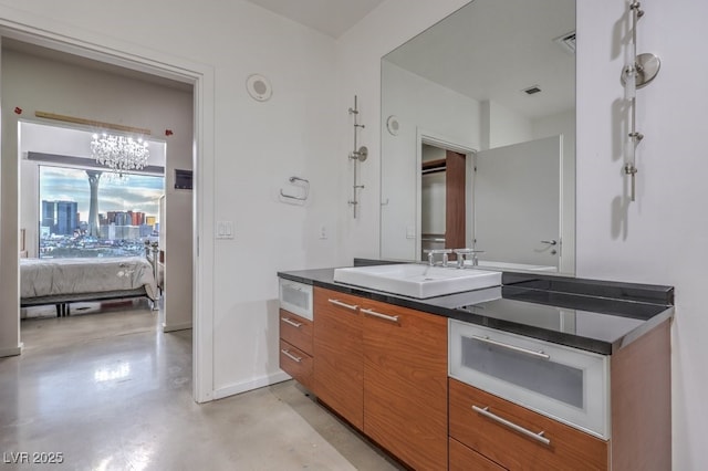 900 Las Vegas Blvd Unit 1208, Las Vegas, NV 89101 - ensuite bathroom with finished concrete flooring, vanity, a chandelier, and baseboards