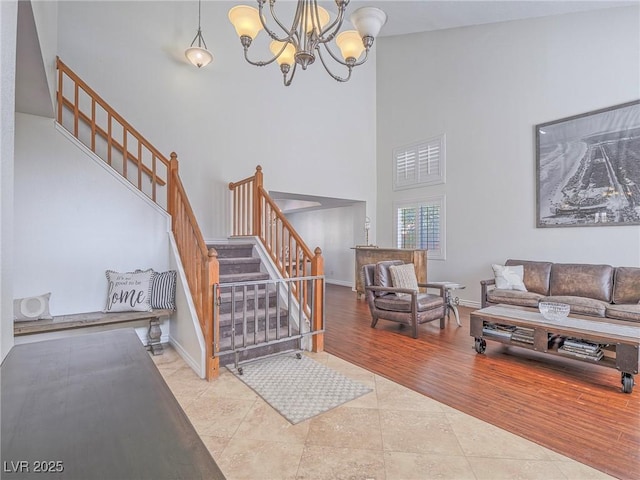 2732 Dune Cove Rd, Las Vegas, NV 89117 - tiled living room featuring stairway, a chandelier, a high ceiling, and baseboards