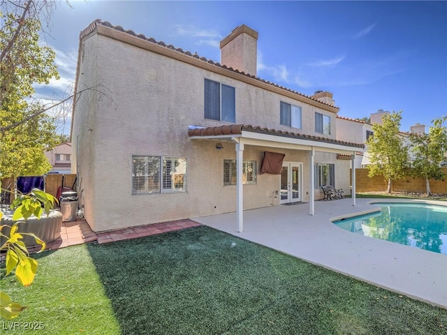 2732 Dune Cove Rd, Las Vegas, NV 89117 - rear view of property with a fenced backyard, stucco siding, a tiled roof, a chimney, and a patio area