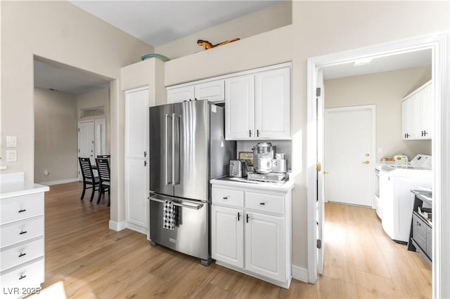 10504 Button Willow Dr, Las Vegas, NV 89134 - kitchen featuring high end fridge, independent washer and dryer, light wood-style floors, and white cabinetry