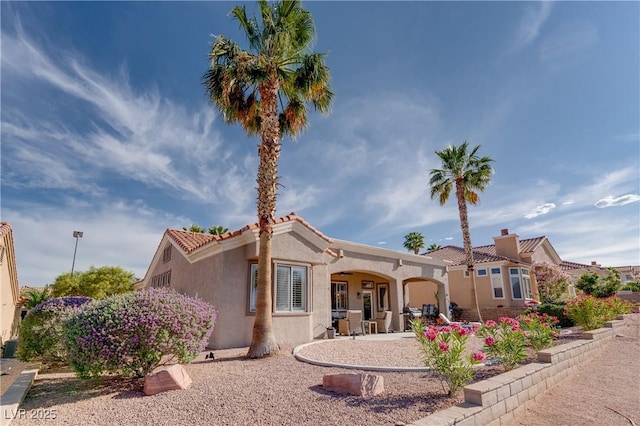 10504 Button Willow Dr, Las Vegas, NV 89134 - view of front of property featuring stucco siding, a tiled roof, and a chimney