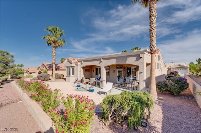 10504 Button Willow Dr, Las Vegas, NV 89134 - rear view of property featuring stucco siding and a patio area