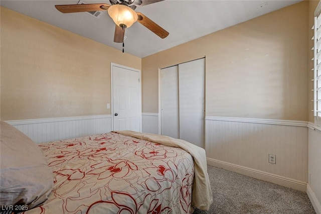 839 Benita Pl, Boulder City, NV 89005 - bedroom featuring wainscoting, a closet, carpet, and a ceiling fan