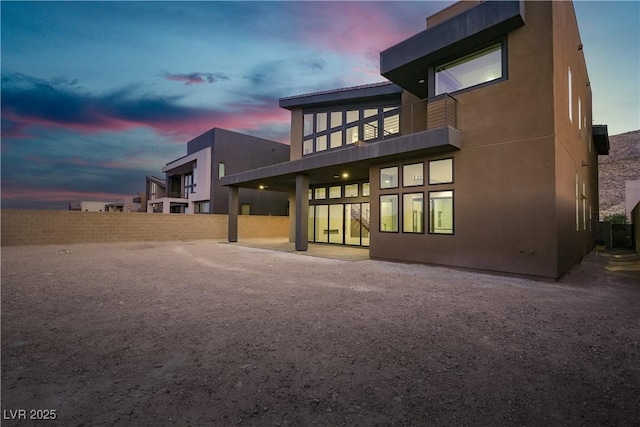 5364 Succulent Rose Dr, Las Vegas, NV 89135 - back of house at dusk with a balcony and stucco siding