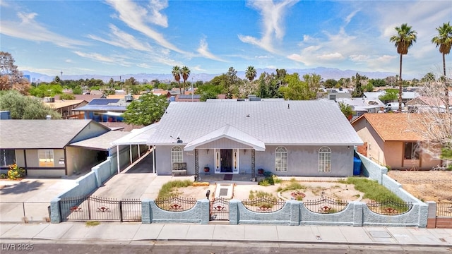 1112 Sandy Cove St, Las Vegas, NV 89110 - view of front facade with a fenced front yard, a carport, driveway, a residential view, and a mountain view