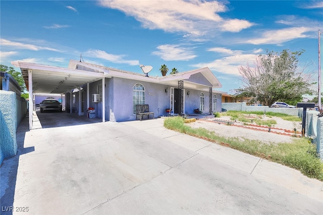 1112 Sandy Cove St, Las Vegas, NV 89110 - view of front facade featuring driveway, stucco siding, a carport, and covered porch