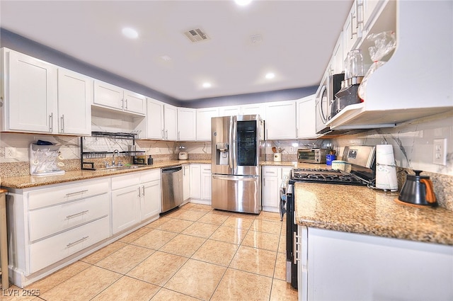 1112 Sandy Cove St, Las Vegas, NV 89110 - kitchen featuring appliances with stainless steel finishes, decorative backsplash, white cabinets, light tile patterned floors, and recessed lighting
