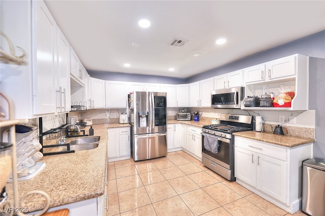 1112 Sandy Cove St, Las Vegas, NV 89110 - kitchen featuring appliances with stainless steel finishes, a sink, white cabinets, light tile patterned floors, and recessed lighting