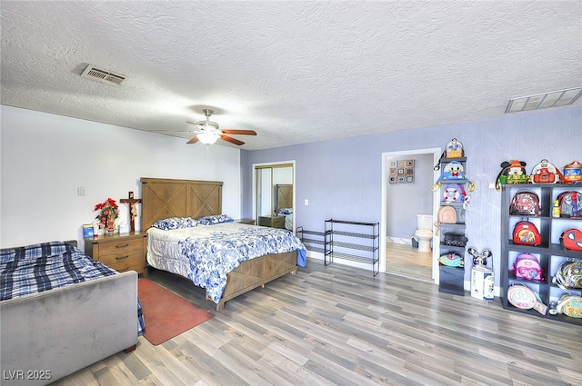1112 Sandy Cove St, Las Vegas, NV 89110 - bedroom with wood finished floors, a textured ceiling, a ceiling fan, and baseboards