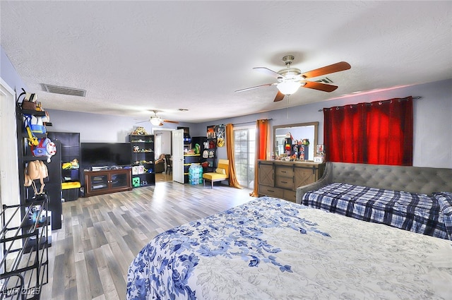 1112 Sandy Cove St, Las Vegas, NV 89110 - bedroom featuring wood finished floors, a textured ceiling, and ceiling fan