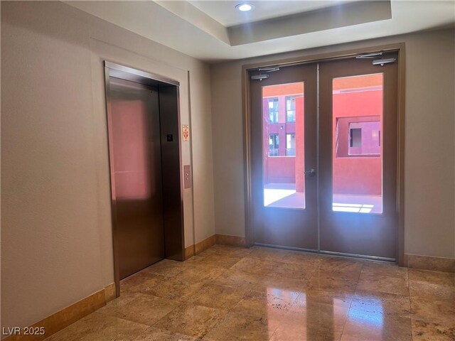 87 E Agate Ave Unit 202, Las Vegas, NV 89123 - entrance foyer with elevator, baseboards, a tray ceiling, french doors, and recessed lighting