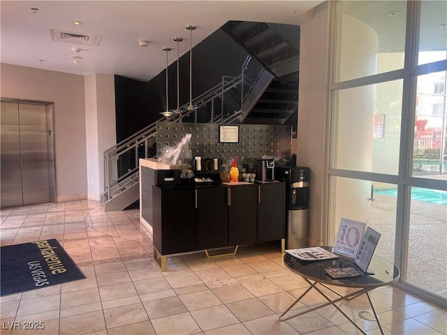 87 E Agate Ave Unit 202, Las Vegas, NV 89123 - kitchen featuring elevator, light tile patterned floors, dark cabinetry, and water heater