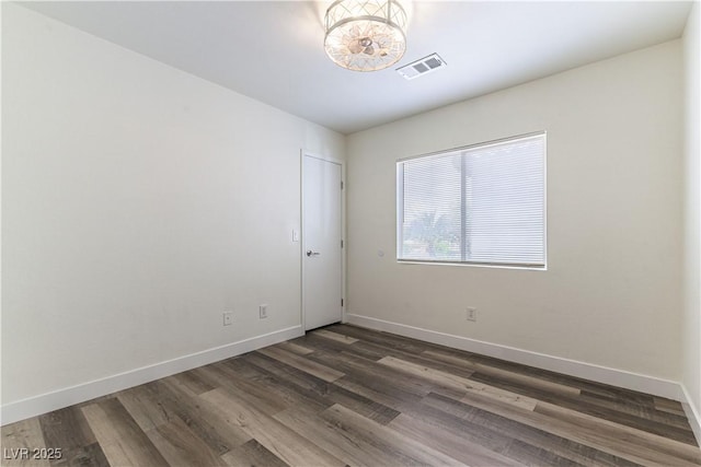 10162 Lemon Thyme St, Las Vegas, NV 89183 - spare room with dark wood-type flooring, baseboards, and a chandelier