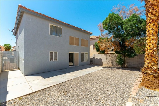 10162 Lemon Thyme St, Las Vegas, NV 89183 - rear view of property with stucco siding, a fenced backyard, a tile roof, a patio area, and a gate