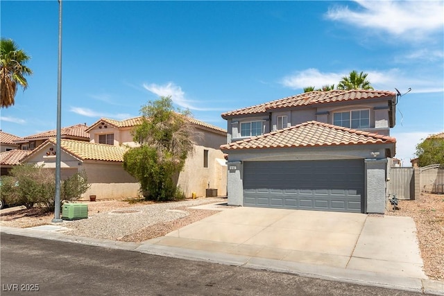 10162 Lemon Thyme St, Las Vegas, NV 89183 - mediterranean / spanish house with stucco siding, a tiled roof, an attached garage, and concrete driveway