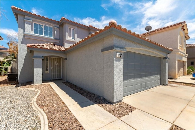 10162 Lemon Thyme St, Las Vegas, NV 89183 - mediterranean / spanish-style home featuring stucco siding, a garage, a tile roof, and concrete driveway