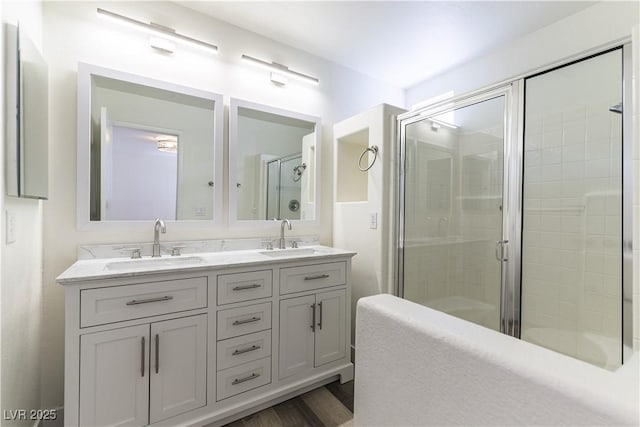 10162 Lemon Thyme St, Las Vegas, NV 89183 - full bathroom featuring a tile shower, double vanity, and wood finished floors