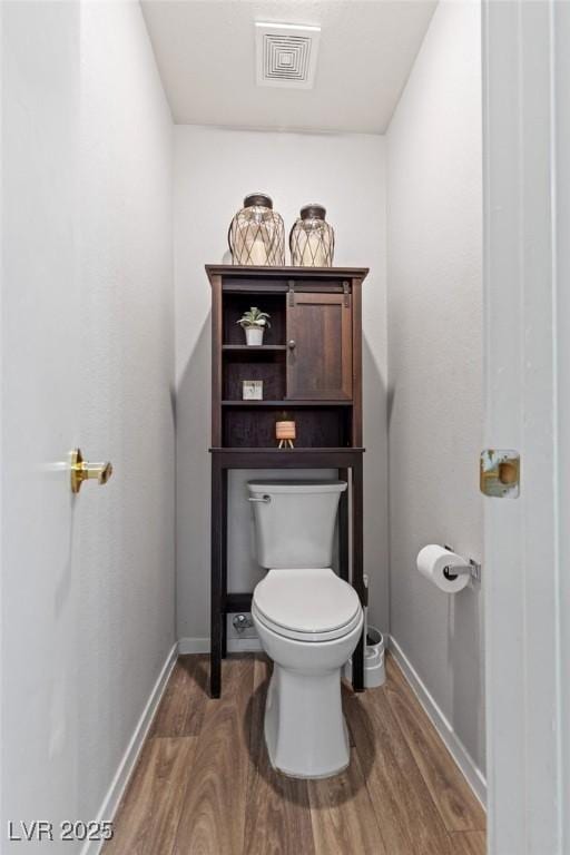 1079 Oak Shade Ln, Henderson, NV 89015 - bathroom featuring wood finished floors, toilet, and baseboards
