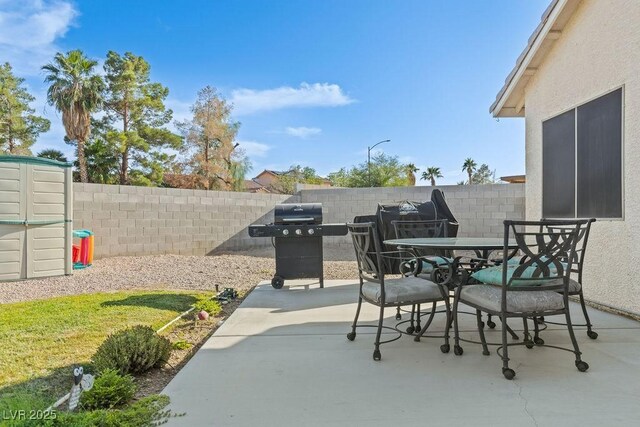 1079 Oak Shade Ln, Henderson, NV 89015 - fenced backyard with a patio, outdoor dining area, and grilling area