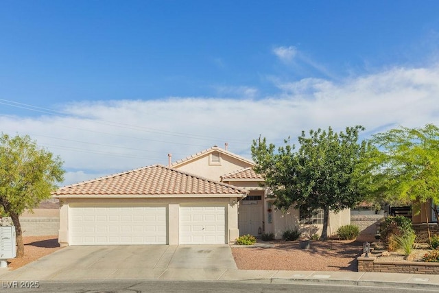 1079 Oak Shade Ln, Henderson, NV 89015 - mediterranean / spanish house featuring stucco siding, concrete driveway, a tiled roof, and a garage