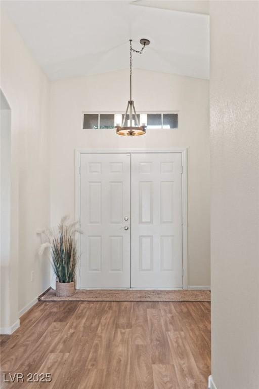 1079 Oak Shade Ln, Henderson, NV 89015 - foyer entrance featuring baseboards, wood finished floors, and arched walkways