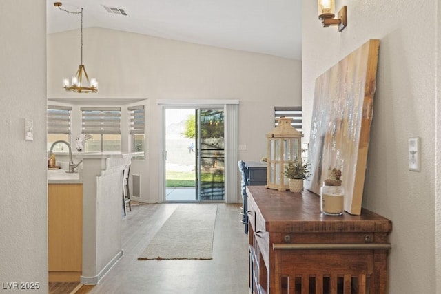 1079 Oak Shade Ln, Henderson, NV 89015 - entryway featuring a chandelier, light wood-type flooring, and high vaulted ceiling