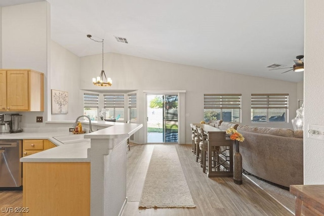 1079 Oak Shade Ln, Henderson, NV 89015 - kitchen with a sink, stainless steel dishwasher, light brown cabinetry, lofted ceiling, and a peninsula