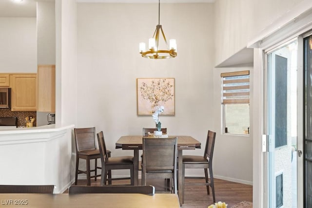 1079 Oak Shade Ln, Henderson, NV 89015 - dining space featuring a chandelier, wood finished floors, and baseboards