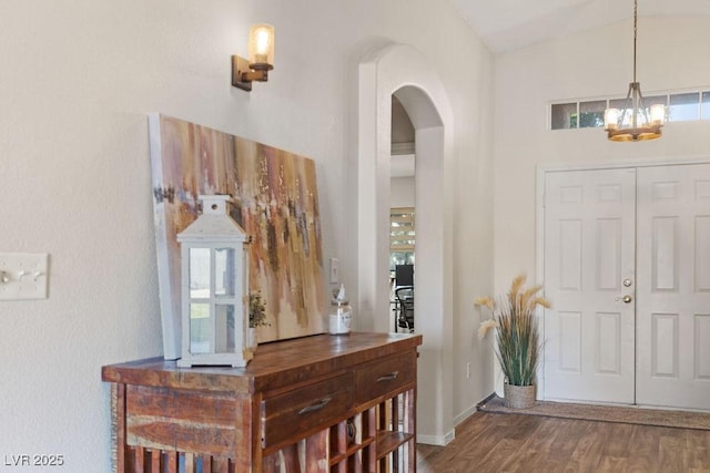 1079 Oak Shade Ln, Henderson, NV 89015 - foyer featuring wood finished floors, arched walkways, a chandelier, and baseboards