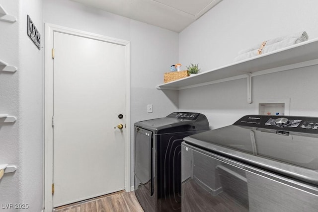 1079 Oak Shade Ln, Henderson, NV 89015 - laundry room with separate washer and dryer and wood finished floors
