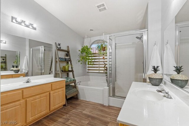 1079 Oak Shade Ln, Henderson, NV 89015 - full bath with vanity, a shower stall, a bath, wood finished floors, and vaulted ceiling