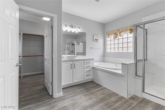 2231 Desert Prairie St, Las Vegas, NV 89135 - bathroom with vanity, a marble finish shower, a garden tub, and wood finished floors