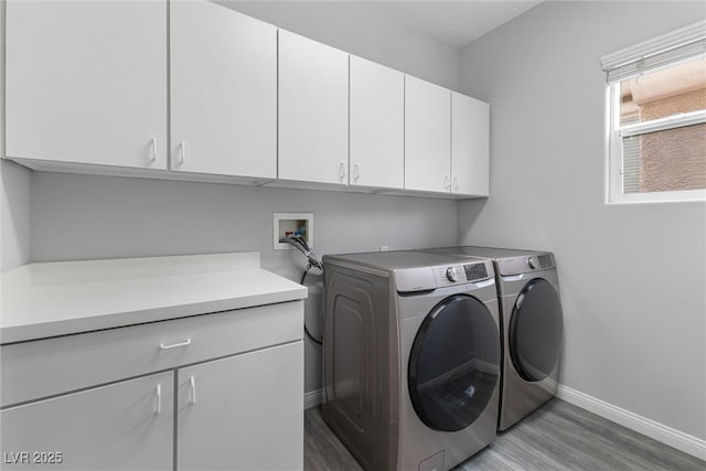 2231 Desert Prairie St, Las Vegas, NV 89135 - laundry area with cabinet space, wood finished floors, independent washer and dryer, and baseboards