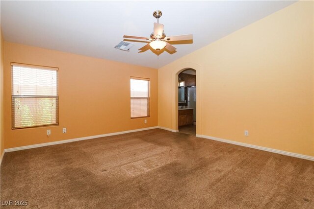 2787 Sunken Ship St, Laughlin, NV 89029 - spare room with carpet floors, a ceiling fan, arched walkways, and baseboards