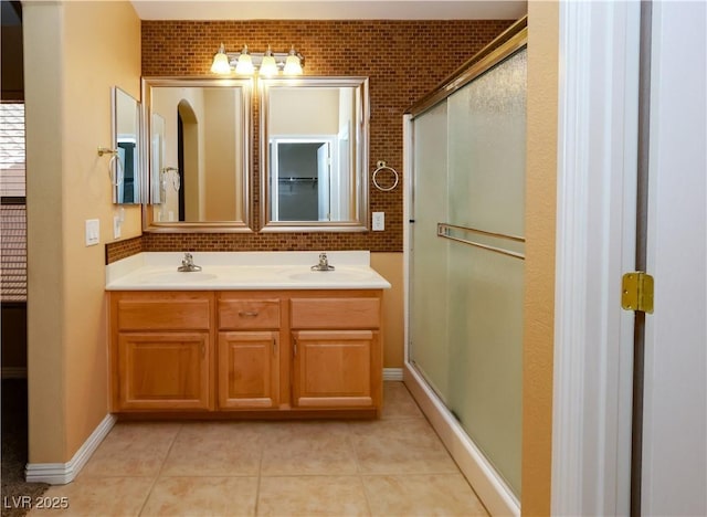 2787 Sunken Ship St, Laughlin, NV 89029 - full bathroom with a stall shower, double vanity, tile patterned floors, and tasteful backsplash