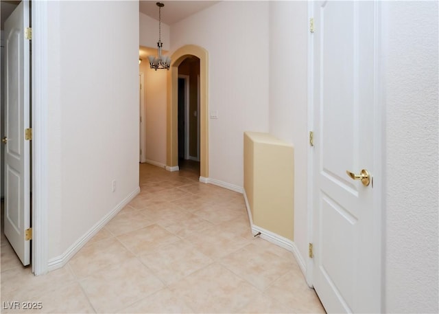 2787 Sunken Ship St, Laughlin, NV 89029 - hall with arched walkways, light tile patterned flooring, and baseboards