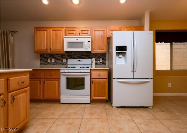 2787 Sunken Ship St, Laughlin, NV 89029 - kitchen with white appliances, light tile patterned floors, tasteful backsplash, light countertops, and recessed lighting