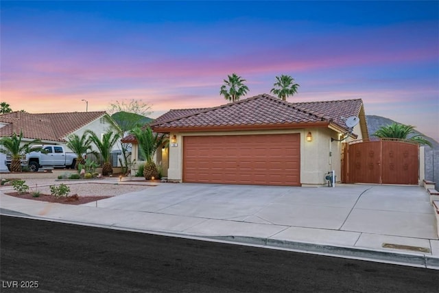 160 Coastal Pier Ct, Henderson, NV 89002 - mediterranean / spanish-style home with a tiled roof, a gate, concrete driveway, and stucco siding