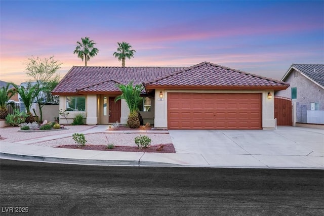 160 Coastal Pier Ct, Henderson, NV 89002 - view of front of home with a tile roof, stucco siding, a garage, concrete driveway, and a gate