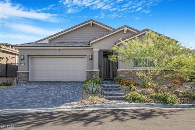 2771 Free Formed Ct, Las Vegas, NV 89138 - view of front of house with stone siding, stucco siding, a garage, and decorative driveway