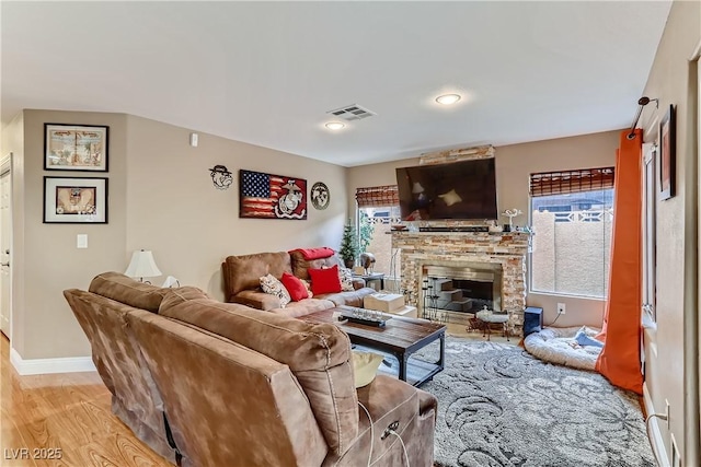 3355 Royal Bay Dr, Las Vegas, NV 89117 - living room featuring a fireplace, light wood-type flooring, and baseboards