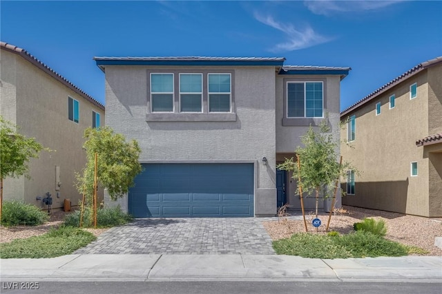 4448 Mahogany Hills Ave, Las Vegas, NV 89141 - traditional-style house with stucco siding, a garage, and decorative driveway