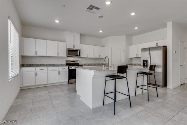 4448 Mahogany Hills Ave, Las Vegas, NV 89141 - kitchen with appliances with stainless steel finishes, a sink, healthy amount of natural light, white cabinets, and recessed lighting