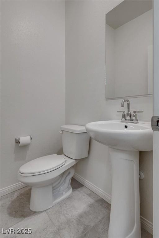 4448 Mahogany Hills Ave, Las Vegas, NV 89141 - half bathroom featuring toilet, baseboards, and a sink