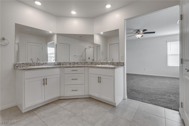 4448 Mahogany Hills Ave, Las Vegas, NV 89141 - bathroom with ceiling fan, double vanity, a stall shower, tile patterned flooring, and baseboards