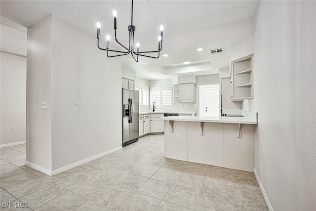 5316 Fieldstone Rd, Las Vegas, NV 89107 - kitchen featuring stainless steel fridge with ice dispenser, a peninsula, open shelves, a sink, and a chandelier