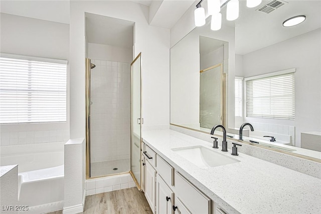 5316 Fieldstone Rd, Las Vegas, NV 89107 - bathroom with vanity, a stall shower, a bath, and wood finished floors