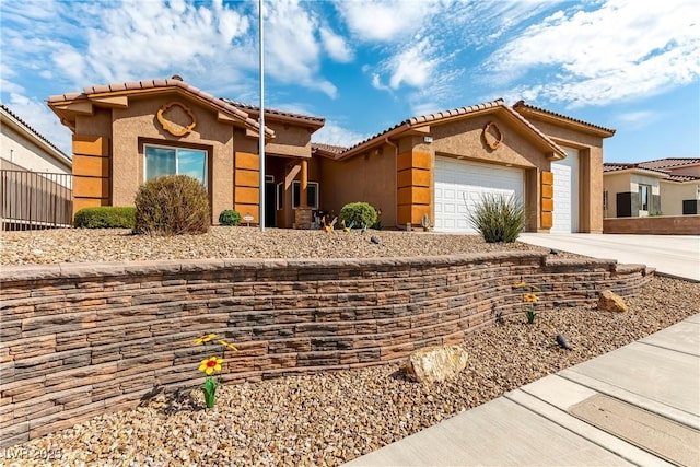 3811 Queen Elizabeth Ct, Laughlin, NV 89029 - mediterranean / spanish-style home featuring a garage, stucco siding, concrete driveway, and a tiled roof
