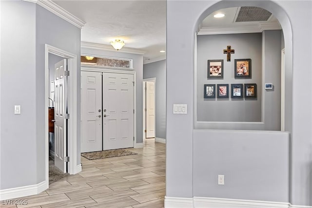 3811 Queen Elizabeth Ct, Laughlin, NV 89029 - foyer entrance with ornamental molding, arched walkways, wood finish floors, and baseboards