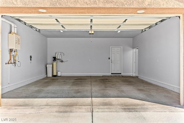 3811 Queen Elizabeth Ct, Laughlin, NV 89029 - garage featuring baseboards and tankless water heater
